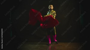 Male dancer or toreador imitating moves of matador bullfighter on black smoky background . Man bullfighter dressed in bullfighting costume . Shot on ARRI Alexa cinema camera in Slow Motion
