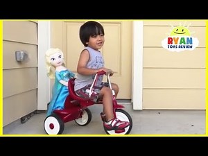 Ryan rides on a bike and play with Disney toys!