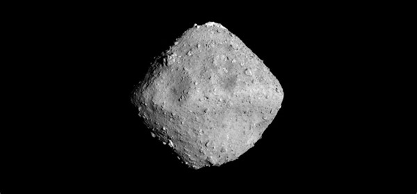 Cometary Dust Smashed Tiny Craters into the Surface of Asteroid Ryugu