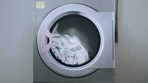 Premium stock video - Industrial washing machine washing clothes. closeup of laundry machine working