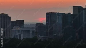 Sun setting up behind skyline buildings, Atlanta, Georgia, USA