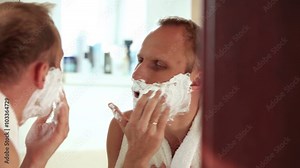 A man sings and dances while shaving in the morning