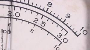 Extreme close-up of dB decibel meter needle movement reading level going up and down on vintage electronic hardware engineering military lab test equipment sound audio device