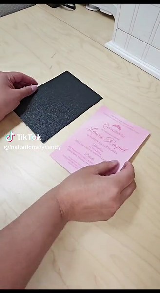 Stand out with this unique black and pink invitation 💌 Watch as a gorgeous 2-inch satin ribbon in striking pink forms an elegant bow, while the laser-cut black sleeve adds a touch of perfection. Encased within a pink envelope, and sealed gracefully with black wax. #quinceañera #sweet16 #birthday