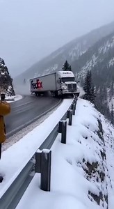FedEx Semi Slides Off Icy Mountain Curve and Tumbles Down Slope 🚚 Vail Pass, Colorado — Thursday, Winter 2025 Handheld iPhone footage captures a FedEx semi-truck hitting black ice on a snowy mountain curve and skidding into a guardrail. The rail breaks, sending the tractor-trailer tumbling down a steep, forested embankment as snow and debris scatter downhill. Nearby witnesses react in shock as the truck disappears below the roadway. Authorities later confirmed no one was injured, and the driver
