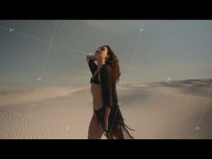 Stylish Woman in Bikini Walking on Sunlit Desert Sand Dunes