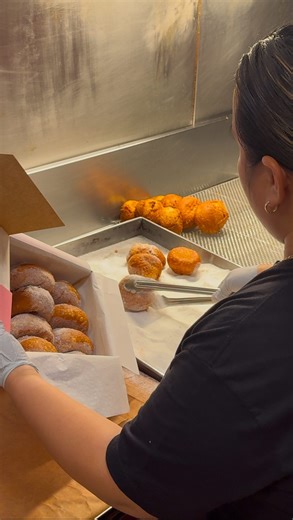 Leonard's Bakery - Official on Instagram: "🎥 Watch the magic happen! 🍩✨ Packing up a dozen of our freshly made, warm malasadas—perfect for sharing (or not 😉) There’s nothing sweeter than a box full of happiness! Stop by and grab your favorites today. 🍩💖 #TheOriginal #LeonardsBakery #Malasadas"