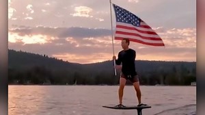 Zuckerberg posts flag-waving video on electric surfboard