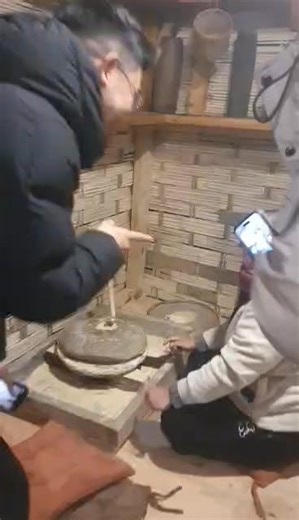 Thinking back to childhood and debating how to use a stone grinder at Bhutan Hydroponics farm, location - upper changbangdu way to Hindu temple, Thimphu. Cont# 77783618 | Bhutan Hydroponics