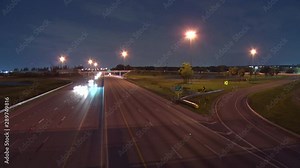 Traffic Speeds North and South on the Florida Turnpike in a 4K Time-Lapse at Sample Road in Pompano Beach from the Overpass Bridge at Night with Some Vehicles Curving to the Right on the Off-Ramp