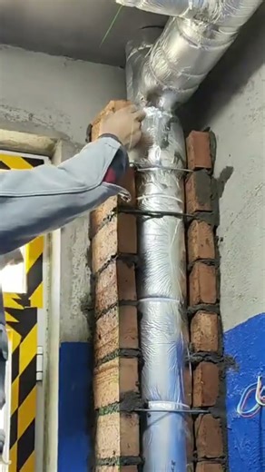 the process of installing bricks and iron nets to cover large pipe in the corners of the room #short