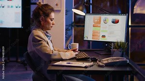 Female office worker checking business statistics at night typing research plan on pc at desk. Entrepreneur analyzing diagrams and financial report, working on progress and development.