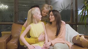 Happy Family Sitting On Sofa At Home And Kissing Each Other | Free Stock Video Footage