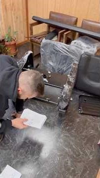 Putting together a brand-new barber chair 💈🔧heavier than it looks! Would you sit in it? Comment 👇