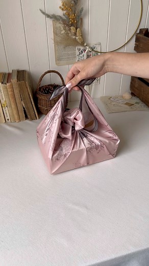 14K views · 121 reactions | Furoshiki: the art of Japanese Cloth Wrapping. This eco friendly wrapping alternative allows the wrapping cloth to be re-used, saving tonnes of wrapping paper being sent to landfill each year. This tutorial shows how to wrap and a tie handle! Perfect for transporting your gift. | Fable England | Facebook