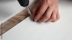 Furniture Assembly Manual. Workman Reading Instruction Installing Cabinet Making House Renovation Indoors.