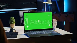 Green screen laptop in home office used for developing software applications. Mockup notebook used by teleworking IT specialist for programming, camera A close up panning shot