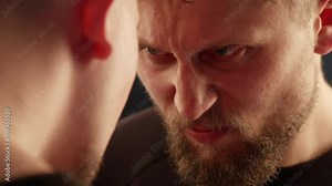 Two fighters eye to eye confrontation showing an extreme build up of tension before the fight. Close up portrait.