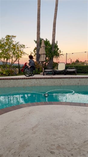 🌅 Alt text: a woman in a wheelchair starts the video, leaves, then appears on the other side of a pool, stops in a wheelie, spins, and then comes back and ends the video. #Wheelie #Random #Satire #Pool #Sunset | Aly Corvin