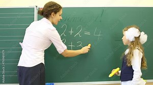 Girl and teacher stand and solve simple math examples