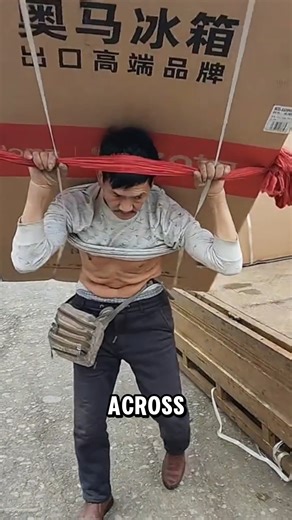 This delivery worker carries a 300 pound refrigerator using a traditional head strap technique | XUrbanSimsX