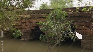 Pan shows ancient corbeled laterite stone arch bridge design, Cambodia