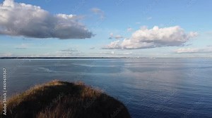 4K Aerial landscape drone shot of the beautiful southern English coast line during sunset, facing Poole and Bournemouth, in Dorset, at Old Harry Rocks.