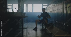 MS DOLLY IN Caucasian male wraps his hands in locker room before boxing martial arts training. 4K UHD 60 FPS SLOW MOTION