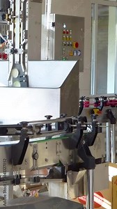 Production of table horseradish with beets. Processing horseradish into food seasoning. Conveyor for packaging table horseradish with red beets into jars. Vertical video.