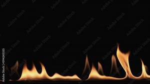 Slow motion. Flame tongues and their reflection on a black background.