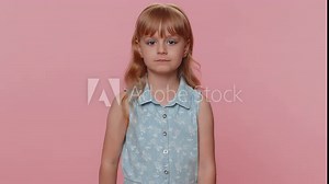 Shh be quiet please. Preteen child girl kid presses index finger to lips makes silence hush gesture sign do not tells gossip secret. Little toddler children isolated alone on studio pink background Stock Video