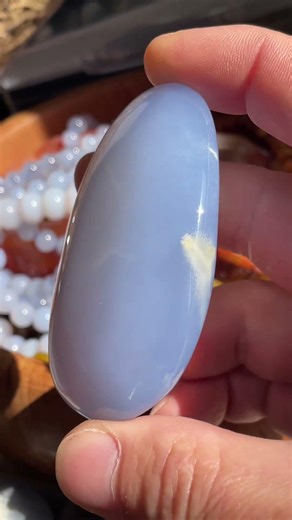 Golden feather inside blue chalcedony