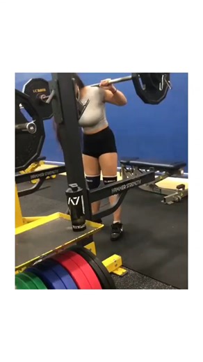 @memesrelatablelife.vibe on Instagram: "The post shares a 23-second video of an unidentified young Asian woman executing multiple back squats with an estimated 135-185 lb barbell in a Hammer Strength-equipped gym, emphasizing her athletic form in a gray crop top and black shorts. From @chicas_depor , a Spanish-language account curating content on "pretty and sporty girls," this fits its niche of aesthetic fitness videos that blend empowerment with visual appeal, driving rapid engagement of 6,900
