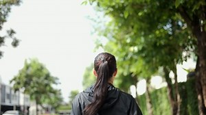 Attractive beautiful woman wearing sportswear running in park. Fit woman jogging outdoor at at village. Workout exercise in the morning. Healthy and active lifestyle concept.