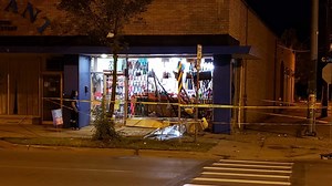Car crashes into storefront, driver flees scene