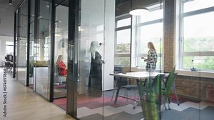 A diverse group of colleagues collaborates using laptops, mobiles, and tablets to tackle business challenges and enhance productivity through teamwork and innovative technology.