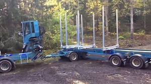 Specialized Logging Truck Maneuvering Tall Trees