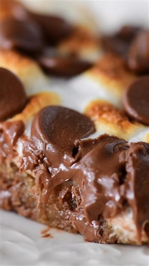 28K views · 215 reactions | This S’mores Bars recipe has a graham cracker cookie crust topped with toasted marshmallows and Hershey Kisses. Perfect for summer parties! https://www.thegunnysack.com/smores-bars-recipe/ #smores #smorefun #thegunnysack | The Gunny Sack | Facebook