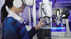 Concept of virtual reality, simulation, Robot arm and future technology.Asian Engineers Maintenance Robot Arm at Lab. they are in a High Tech Research Laboratory with Modern Equipment.
