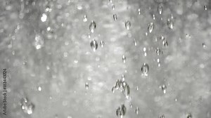 Drops of water moving with force under pressure in a water font