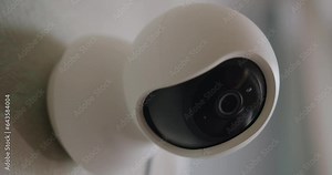 Closeup of video baby monitor with camera for watching baby at nursery room. Modern digital device with motion sensor for monitoring child while he sleeping. Safety and security concept.