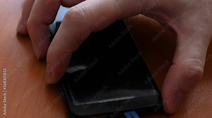 close-up repair of a smartphone, the hands of a master using a tool dismantle a smartphone for repair. selective focus. phone touchscreen replacement workshop