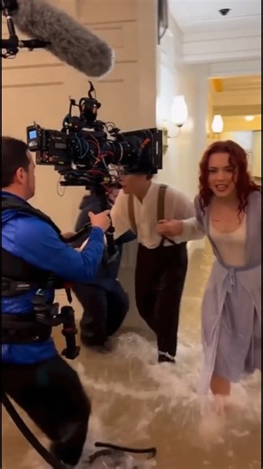 This BTS moment captures the tension right before one of Titanic’s most heartbreaking scenes. The actors stand inches apart, drenched, shivering, and still completely in character. Crew members, lights and cameras surround them, but the emotion between them feels 100% real. That’s why this love story still hits so hard, even decades later. | Hollywood FrameLab