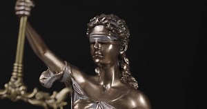 Lady justice statue law order judge blind rights concept books close up 9