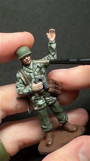 Army men painting Airfix German Paratrooper