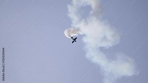 Corkscrewing Aerobatic Airplane Spiraling Down with Smoke Trail at Airshow Stock Video