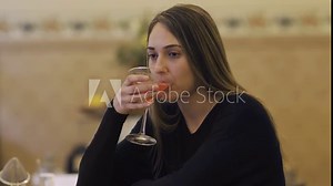 A sad lady having a drink alone in a bar. 4K