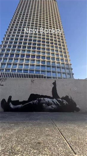 Andrew Jovic on Instagram: "Two children, flat on the pavement, gazing upward — as if the night sky has dropped into the city. But the “stars” above them aren’t constellations. They’re windows. A tower. A hollow house. This newly surfaced work, attributed to Banksy, sits in the shadow of Centre Point — a building long haunted by the idea of luxury kept empty while people sleep outside. Nearby, Centrepoint (the charity) carries the same name as a reminder: the distance between shelter and exposur