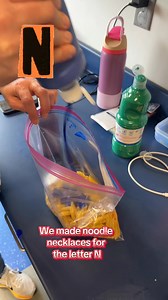 We made noodle necklaces for the letter N! First, we put noodles, tempera paint, and sanitizer in a bag—shook it up—then spread them out to dry. After that, we taped the end of a string for easy threading, and students laced the colorful noodles into necklaces. | Preschool Vibes