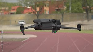 4K footage of drone in static flight at low altitude in a close up shoot over a running track